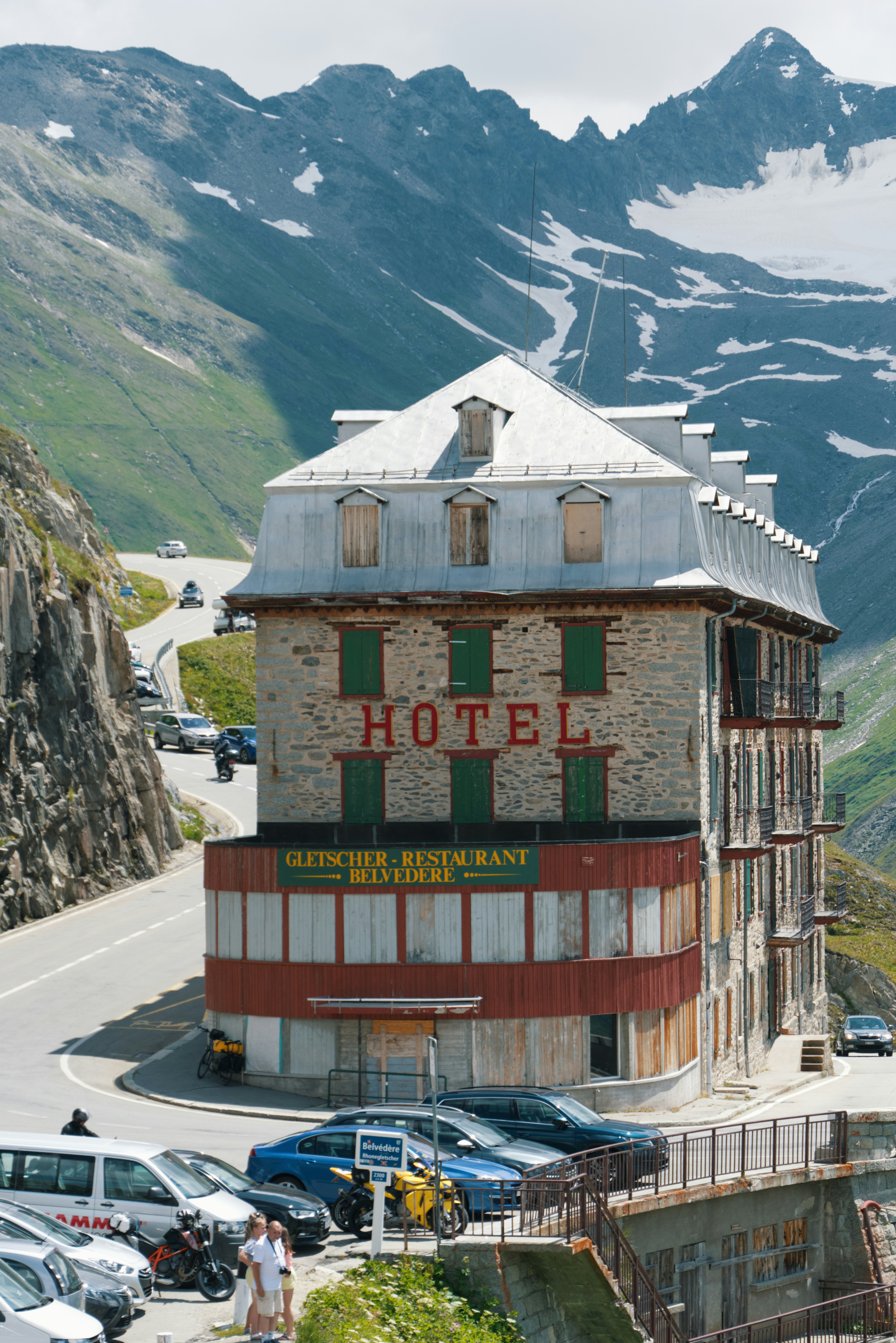 red and white wooden house near mountain during daytime